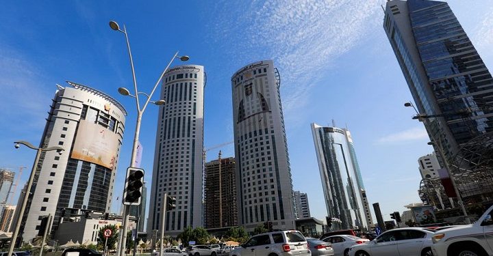 Vehicles are seen in a traffic jam in front of government buildings next to skyscrapers in Doha, Qatar December 21, 2021