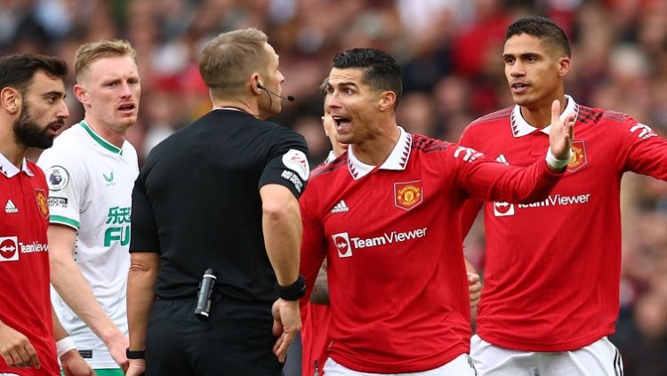 Manchester United's Cristiano Ronaldo reacts before he is shown a yellow card by referee Craig Pawson.