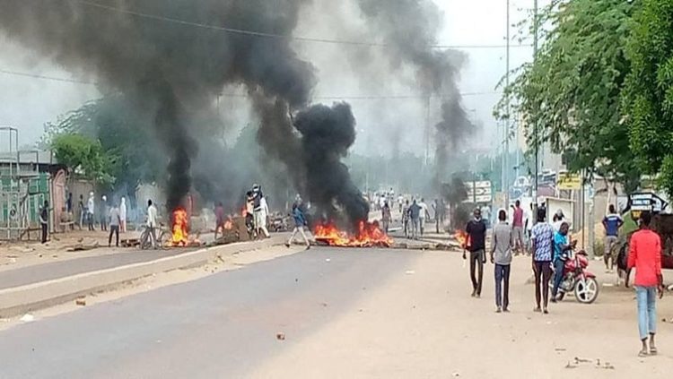 Smoke erupts from tyres set on fire as people protest in N'Djamena, Chad.