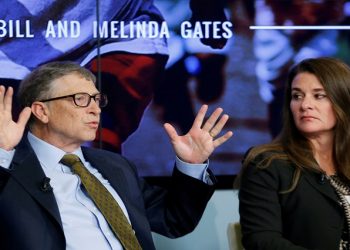 Bill and Melinda Gates attend a debate.