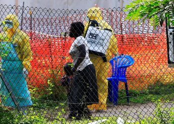 FILE PHOTO: A woman and her child arrive for ebola related investigation at the health facility at the Bwera general hospital near the border with the Democratic Republic of Congo in Bwera, Uganda, June 14, 2019.