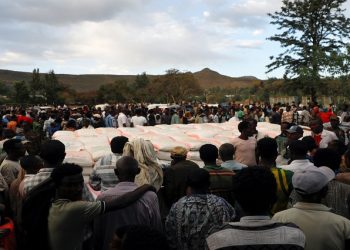 FILE PHOTO: People stand in line to receive food donations, at the Tsehaye primary school, which was turned into a temporary shelter for people displaced by conflict, in the town of Shire, Tigray region, Ethiopia, March 15, 2021. Picture taken March 15, 2021.    REUTERS/Baz Ratner/File Photo
