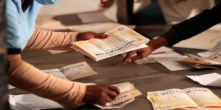 Election officials count ballots after the closing of the local government elections, at a farm in Alewynspoort, outside Johannesburg, November 2021