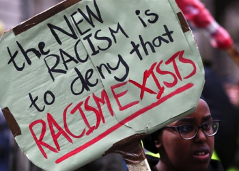 A student holds up a placard during an anti-racism march.