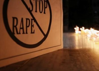 File image: A poster is seen at a candle-lit march to remember rape and murder victims.