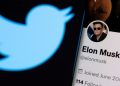 File Photo: Elon Musk's Twitter account is seen on a smartphone in front of the Twitter logo in this photo illustration taken, April 15, 2022.