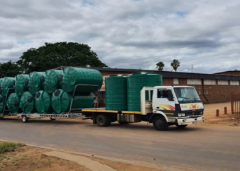 A truck is transporting water tanks.
