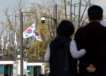South Korean national flags fly at half-mast at the government complex to mourn the victims of a stampede during Halloween festivities that killed and injured many people at the popular Itaewon district in Seoul, South Korea, in this image released by Yonhap on October 30, 2022.