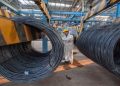 (File Image) An employee inspects newly-made steel coils at a steel plant in Lianyungang, Jiangsu province October 11, 2014.