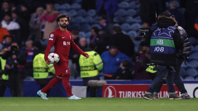 Liverpool's Mohamed Salah holds the match ball at full time after scoring a hat-trick.