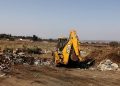A payloader seen clearing a dumpsite in Johannesburg