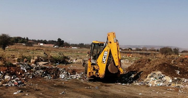 A payloader seen clearing a dumpsite in Johannesburg