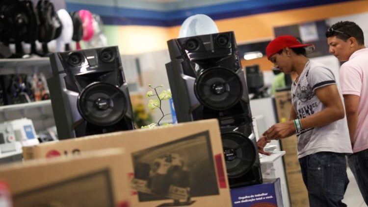 Customers look at speakers at a Casas Bahia store in Sao Paulo February 7, 2013.