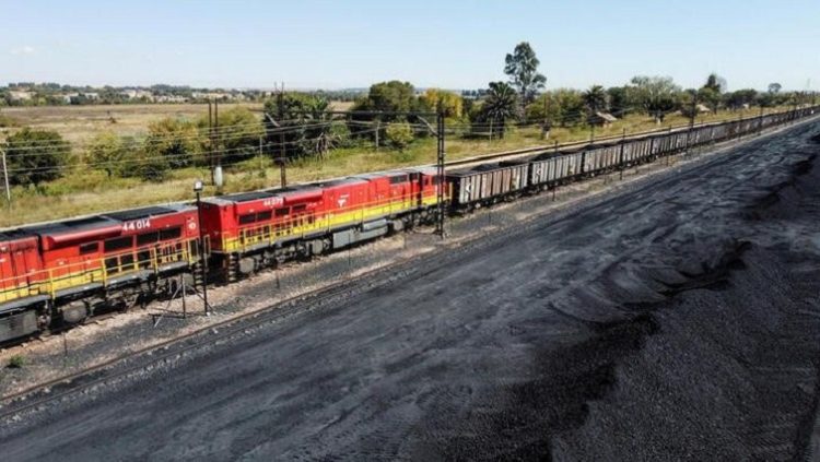A Transnet Freight Rail train is seen next to tons of coal at Bronkhorstspruit station, north-east of Johannesburg, April 26, 2022