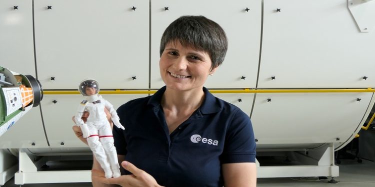 Italian astronaut Samantha Cristoforetti poses for a photo with a Barbie doll version of herself.
