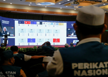 Supporters of Perikatan Nasional watch a video stream for live results of Malaysia's 15th general election at a hotel in Shah Alam, Malaysia November 19, 2022