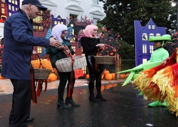 US President Joe Biden and first lady Jill Biden distribute Halloween candy to visiting children at the South Portico of the White House in Washington, U.S., October 31, 2022