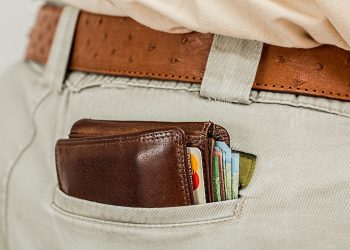 The picture shows a wallet sticking out of a persons pocket.