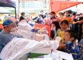 A medical worker collects a swab from a resident during a mass testing for the coronavirus disease (COVID-19) at a makeshift testing site at a stadium in Guangzhou, Guangdong province, China May 30, 2021.