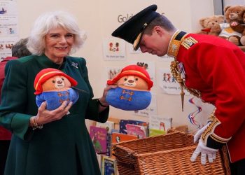 Camilla, the Queen consort, holds Paddington bears as she visits Barnardo's Nursery in Bow, London, Britain November 24, 2022.