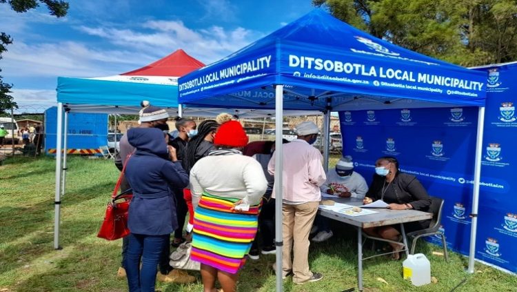 Officials of the Ditsobotla Local Municipality are seen assisting community members with applications for the registration of free basic services on 16 December 2021 as the municipality marked National Reconciliation Day.