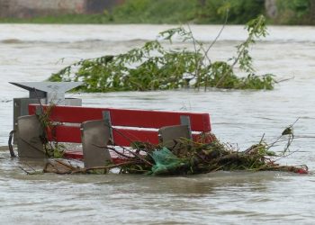 Park benches are seen submerged in water after heavy flooding.