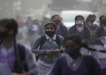 School girls walk towards a school as they reopened after remaining closed for nearly 15 days due to a spike in air pollution, on a smoggy morning in New Delhi, India, November 29, 2021.