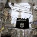 An Islamic State flag hangs amid electric wires over a street in Ain al-Hilweh Palestinian refugee camp, near the port-city of Sidon, southern Lebanon January 19, 2016.