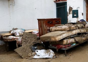Residents' belongings covered in mud pile up outside a building following a landslide on the Italian holiday island of Ischia, Italy November 26, 2022.