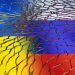 Ukraine and Russian flags are seen through broken glass in this illustration taken March 1, 2022.