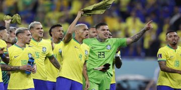 Brazil's Richarlison and Ederson celebrate after the match.