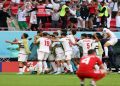 Iran national team celebrating after scoring against Wales