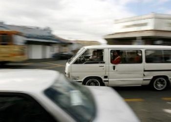 A taxi carrying passengers is seen on the move.