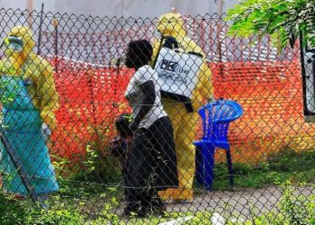 A woman and her child arrive for ebola related investigation at the health facility at the Bwera general hospital near the border with the Democratic Republic of Congo in Bwera, Uganda, June 14, 2019.