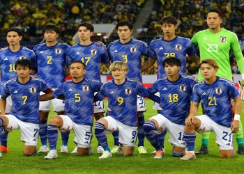 File | Japan players pose for a team group photo before the match against Ecuador