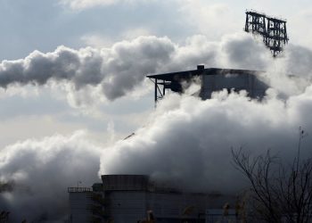 File | Smoke rises from chimneys at a Sinopec refinery in Qingdao