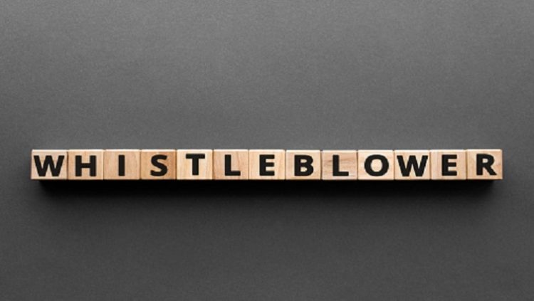 The word 'whistleblower' is written on wooden blocks.