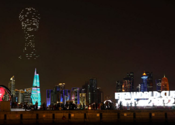 A drone show with the World Cup trophy on display is seen above the skyline of Doha, Qatar - November 15, 2022.