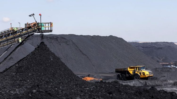 A truck drives past a conveyor pouring coal produced at Canyon Coal's Khanye colliery near Bronkhorstspruit, around 90 kilometres north-east of Johannesburg, South Africa, April 26, 2022.
