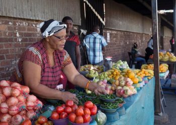 A street trader arranges fresh vegetables and fruit on a street in Pietermaritzburg, South Africa May 21, 2017.