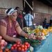 A street trader arranges fresh vegetables and fruit on a street in Pietermaritzburg, South Africa May 21, 2017.