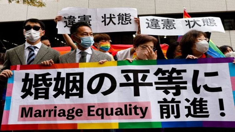Plaintiffs hold placards outside the court after hearing the ruling on same-sex marriage, in Tokyo, Japan, November 30, 2022