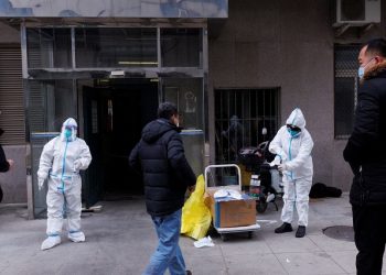 Pandemic prevention workers in protective suits get ready to enter an apartment building that went into lockdown as coronavirus disease (COVID-19) outbreaks continue in Beijing, December 2, 2022.