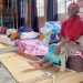 [File Photo]A resident sits on a mattress at a temporary shelter for those displaced as a result of floods in KZN.