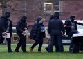FILE PHOTO: Police escorts a person after 25 suspected members and supporters of a far-right group were detained during raids across Germany, in Karlsruhe, Germany December 7, 2022.