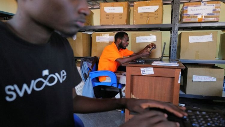 Workers prepare orders inside the office of Ghanaian courier logistics startup Swoove, in Accra, Ghana November 25, 2022.