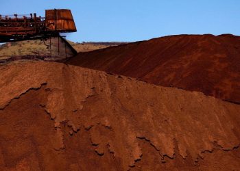 [File Image] : A stacker unloads iron ore onto a pile at a mine