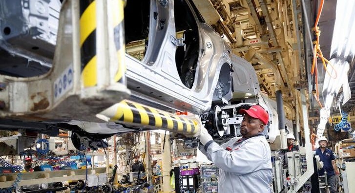 Workers assemble a vehicle as operations begin after flooding in April shut down the Toyota South Africa Motors plant in Durban, South Africa, August 16, 2022.