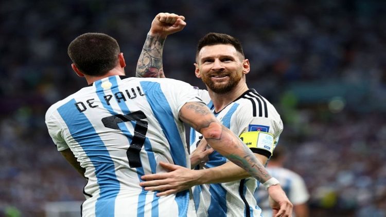 Argentina's Lionel Messi and Rodrigo De Paul celebrate after Nahuel Molina scores their first goal.