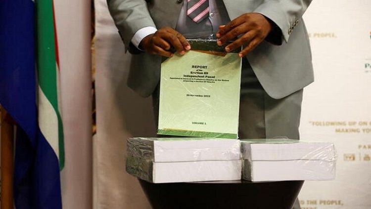 A person unwraps the report ahead of handing it over to the speaker of parliament on whether or not South African president Cyril Ramaphosa should face an impeachment inquiry over the Phala Phala saga in Cape Town, South Africa, November 30, 2022.
